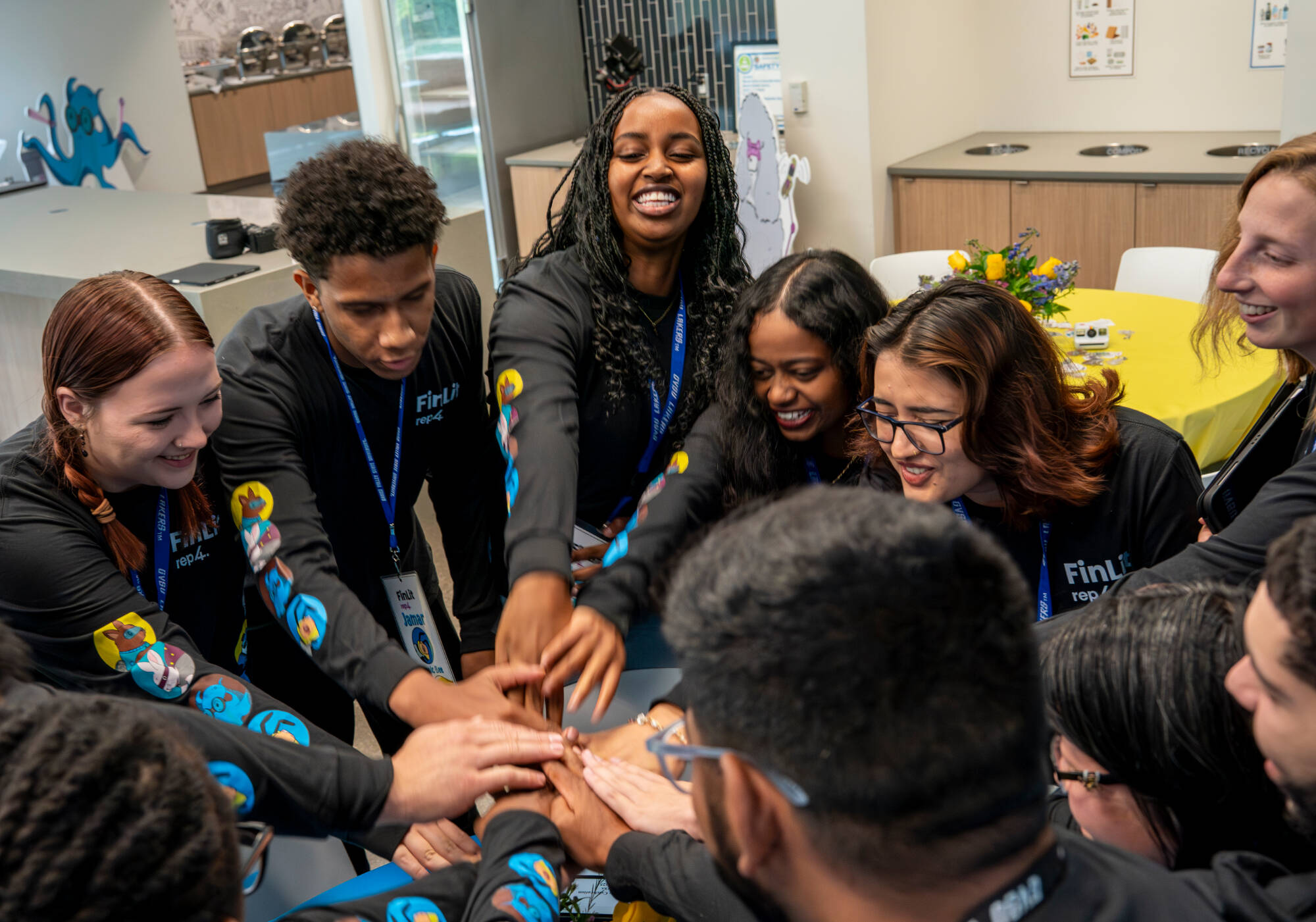 Finance and accounting major Joy Murerwa, top center, works to pump up her classmates before the REP4ⓇFinLit Launch at the John G Russell Leadership Center in Grand Rapids on September 23. Also pictured (from left) film and video major Avary Marshall...